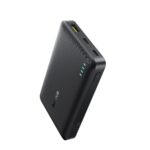 Black slim portable power bank with four blue LED indicators and a USB port on the top edge (textured surface).