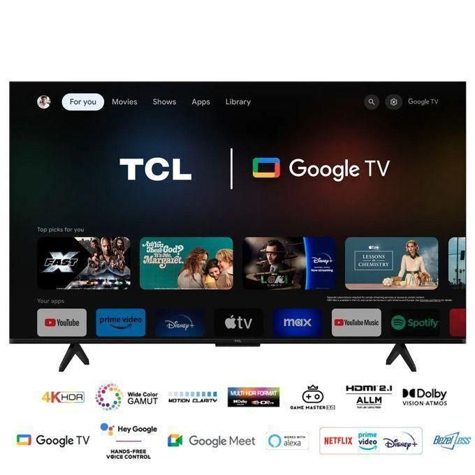 1 (1) TCL flat-screen TV showing Google TV home interface with app thumbnails and a stand on a dark background