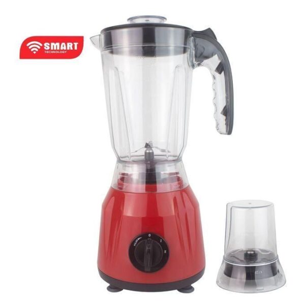 Red countertop blender with a clear glass pitcher and lid, and a separate small grinding attachment beside it.