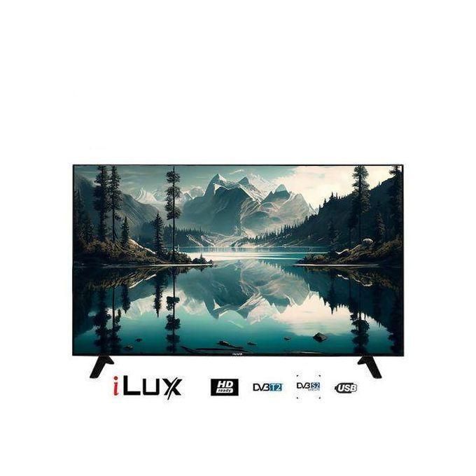1 (3) iLux flat-screen TV on a white background displaying a mountain lake landscape with reflections, stand legs visible and logos beneath.