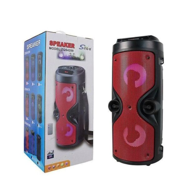 Red portable Bluetooth speaker with two round drivers, shown beside its packaging box.