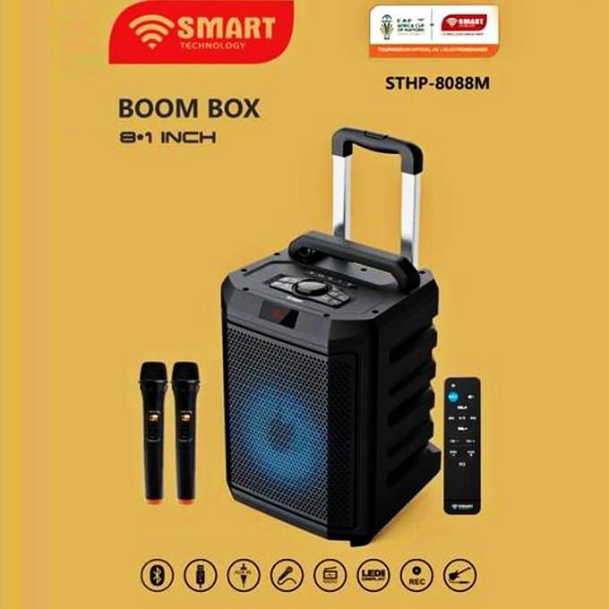 1 (6) Portable Bluetooth boom box with a blue-lit front speaker, carrying handle, two wireless mics, and a tall remote on a yellow background (SHTP-8088M).