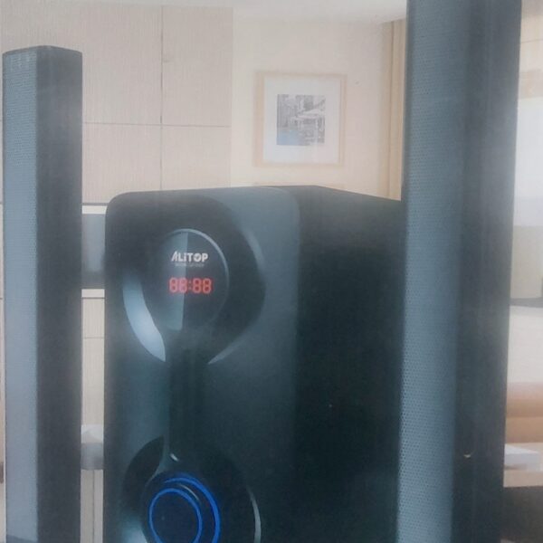 Home theater speaker system with two tall satellite speakers and a central unit showing a digital display reading 88:88 (brand 'ALTOP').