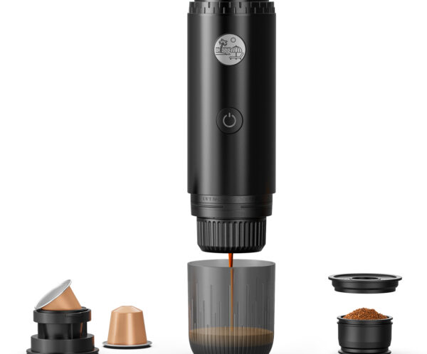 Disassembled black coffee capsule device with lid and several capsules separated, showing internal parts and ground coffee cups lined up below